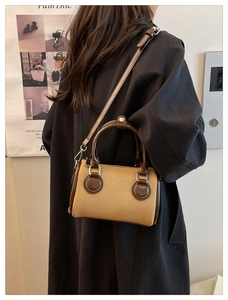 Chic retro Boston bag featuring contrast stitch details and adjustable shoulder strap
