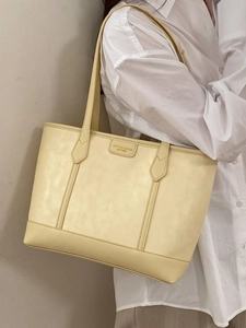 Sac cabas minimaliste en cuir jaune crème avec coutures verticales et bandoulières