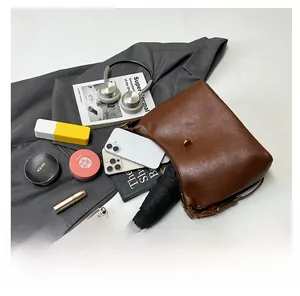Detail showing large capacity of the brown leather tote with daily essentials inside
