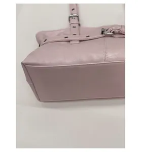 Close-up of pink tote bag showing lychee grain texture and reinforced base stitching