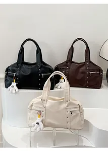 Macro detail of large faux leather hobo bags with zipper pockets and decorative rivets