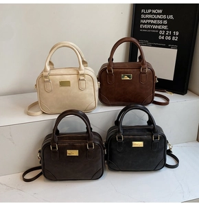 Four colors of vintage Boston handbags in cream, brown, coffee, and black with gold hardware