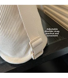 Detail view of adjustable corduroy shoulder strap with cream matching buckle
