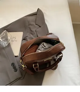 Detailed interior view of a brown leather Boston bag showing spacious storage capacity