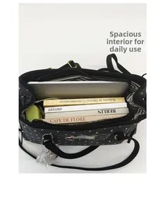 Spacious interior of black polka dot tote bag showing books and laptop storage capacity