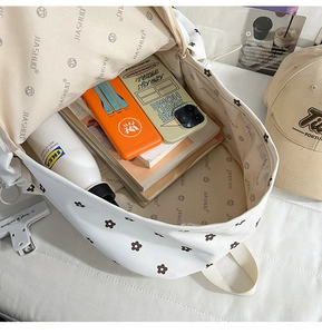 Interior view of floral backpack showing large capacity for books and accessories