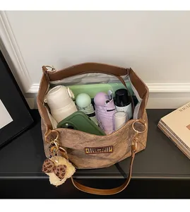 Detailed interior view of a large tote bag packed with daily essentials and leather trim