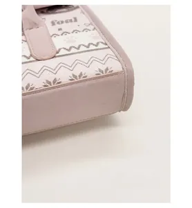 Close-up of pink leather stitching and reinforced bottom base of the tote bag
