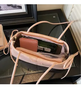 Top view showing the spacious interior of the pink Boston bag with phone and wallet