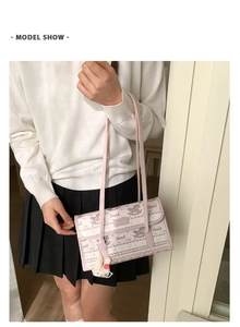 Pink striped shoulder bag with cartoon prints and a white bunny plush charm detail