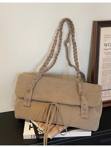 Light brown suede shoulder bag with woven strap and silver rivet accents