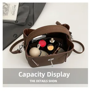 Interior view showing the large storage capacity of the brown leather bucket bag