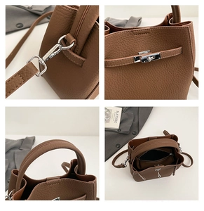 Detail view of brown lychee grain bucket bag featuring silver hardware and inner pockets