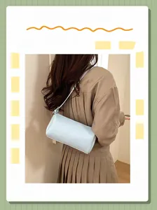 Close-up of light blue lychee pattern pillow bag with crossbody strap on model