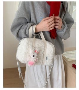 Detail of cream plush square bag with rabbit pendant and chiccaze brand label