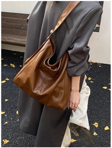 Brown leather hobo bag for women, large capacity shoulder bag shown on model outdoors