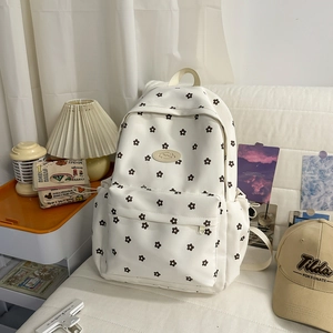 Detail of floral school backpack with cream base and large front zipper pocket