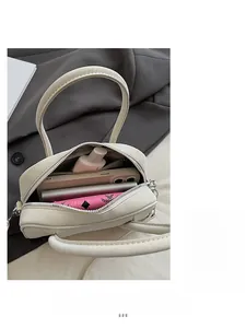 Interior view of off-white box bag showing storage space for phone and wallet