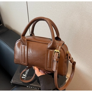 Détail du sac bandoulière marron foncé en cuir texturé avec bandoulière réglable
