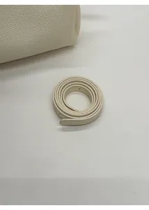 Detail of white lychee grain leather crossbody bag with detachable shoulder strap