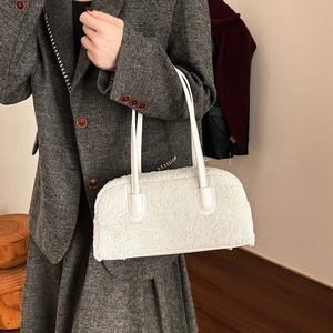 Detail of white faux fur handbag texture with leather strap and metal studs