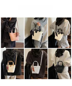 Multiple views of bucket bag styles in various colors with decorative silk scarves