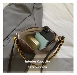 Internal view of dark brown shoulder bag showing large capacity and zipper pocket