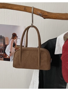 Detail shot of brown vintage leather bowling bag hanging on a rustic wooden hook