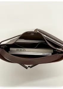 Top view of deep brown pebbled leather tote showing spacious interior with tablet and books