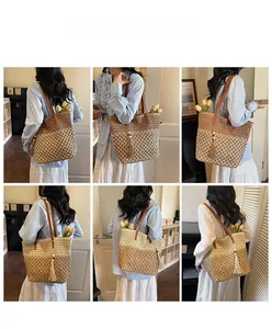 Detail of hand-woven straw tote bag with leather strap and tassel in beach style