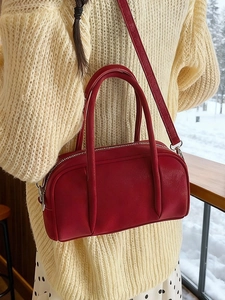 Classic red synthetic leather Boston bag with top handles and adjustable shoulder strap