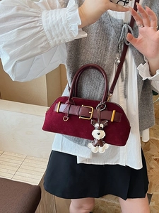 Retro burgundy suede Boston bag with dog charm and metal buckle shown in a mirror selfie