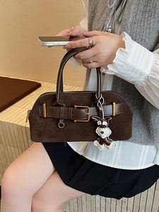 Deep brown suede shell handbag with leather straps and a cartoon dog pendant