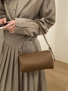 Classic dark brown pebble leather barrel crossbody bag with adjustable strap for women