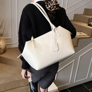 Detail of white large capacity tote bag featuring premium lychee grain leather texture