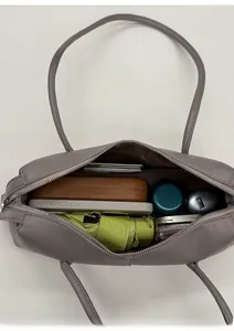 Detail view of the spacious interior of the grey leather tote bag with a zipper pocket