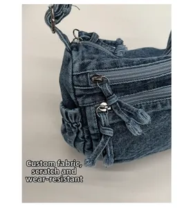 Detail of durable washed denim fabric with decorative zipper tassels and side pocket