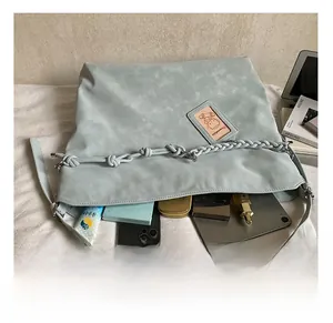 Macro view of blue faux leather tote bag interior showing large storage capacity