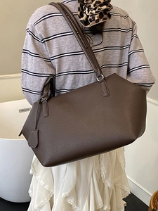 Minimalist large brown lychee texture tote bag worn by a model in a modern style