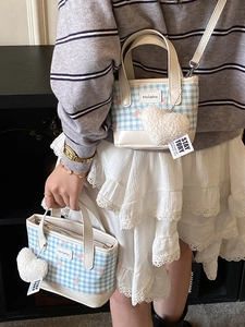 Blue and white plaid bucket bag with heart pendant and adjustable shoulder strap