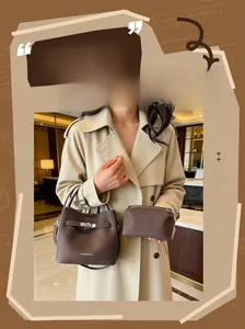 Detail of vintage brown bucket bag set with pebble leather and silver lock clasp