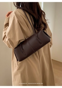 Detail of vintage large brown leather shoulder bag shown in a minimalist elegant styling