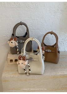 Set di tre borse a secchiello in pelle martellata con chiusure metalliche e ciondoli orsetto