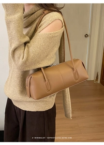 Detail of caramel brown Boston bag showing premium leather texture and silver zipper