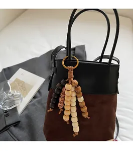 Close-up of a decorative bucket bag pendant with multi-colored natural wooden beads
