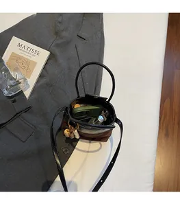 Internal view of brown faux suede bucket bag showing capacity for phone and lipstick