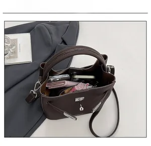 Top view of dark brown leather bucket bag showing large capacity for phone and wallet