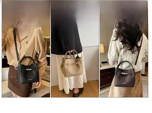 Three-way carry style of lychee grain bucket bag with metallic twist lock and handle