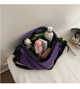 Internal view of purple plaid nylon tote bag showing spacious high capacity storage