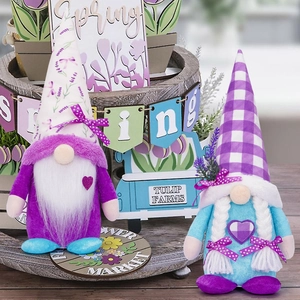 Light up lavender garden gnome figurines with floral hats on a wooden display